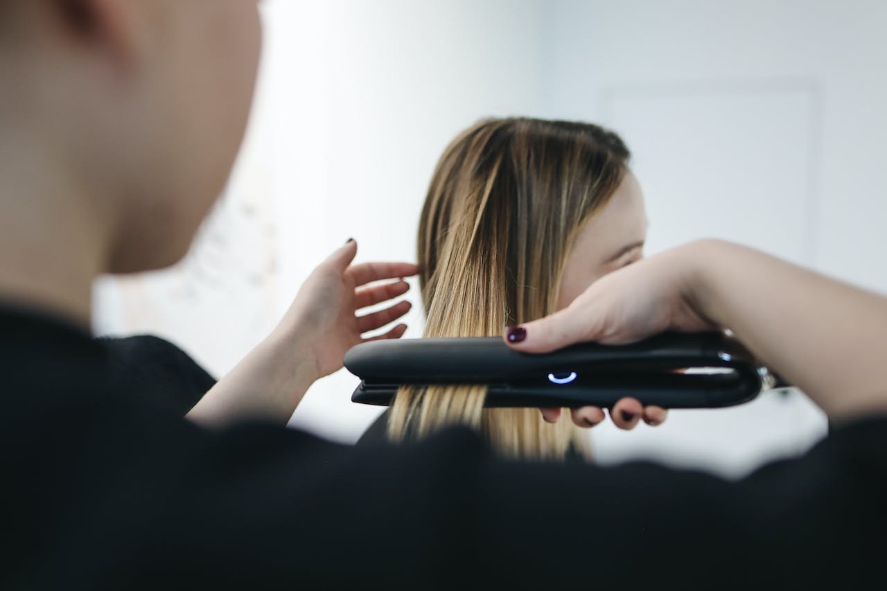 Female getting her hair straightened