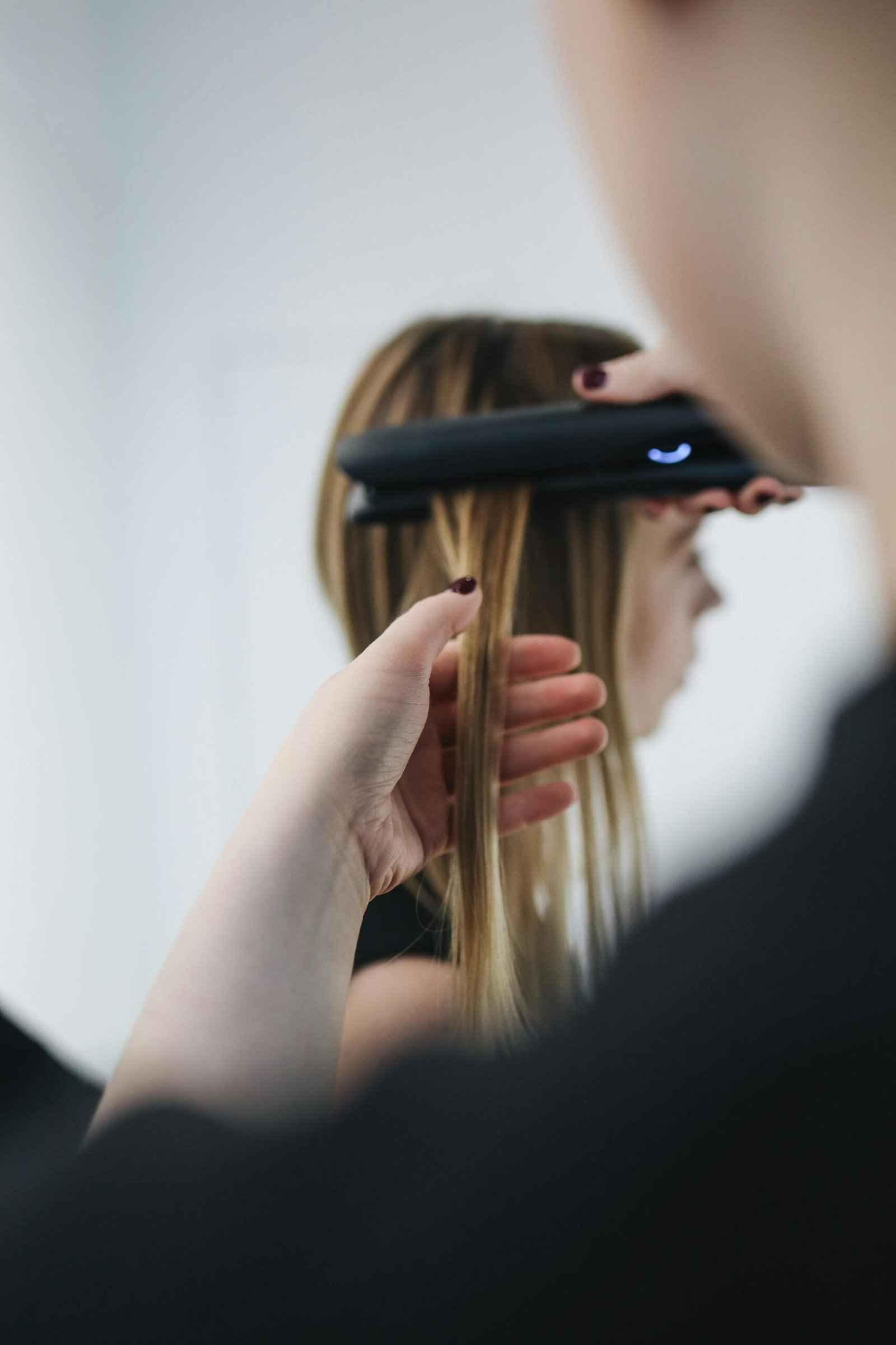 Hairdresser Straightening Clients Hair